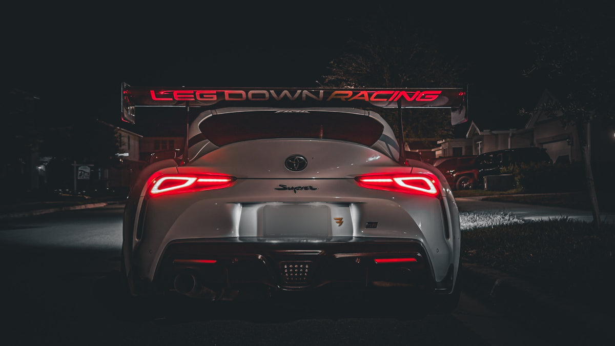 Leg Down Racing GR Supra at night, rear view